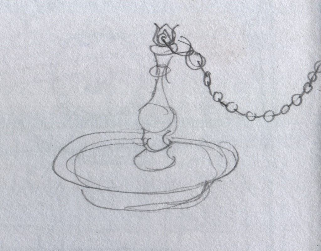 This is an oil-burning metal lamp that I saw in a display case. The open pan at the lamp's base contains the oil, and people rest wicks on the pan's brim, and light the wicks. The brim can support one or many wicks, depending on the need for light.  A chain is one several methods of supporting a lamp. Other lamps stand atop built-in pedestals or are mounted on the wall. A hanging lamp is called തൂക്കു വിളക്ക്  (thookku vilakku). Hill Palace Museum, Thripunithura.